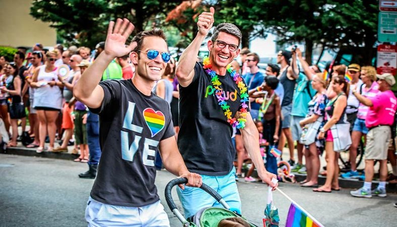 Couple walking with child during Capital Pride Parade - LGBTQ Summer Events in Washington, DC