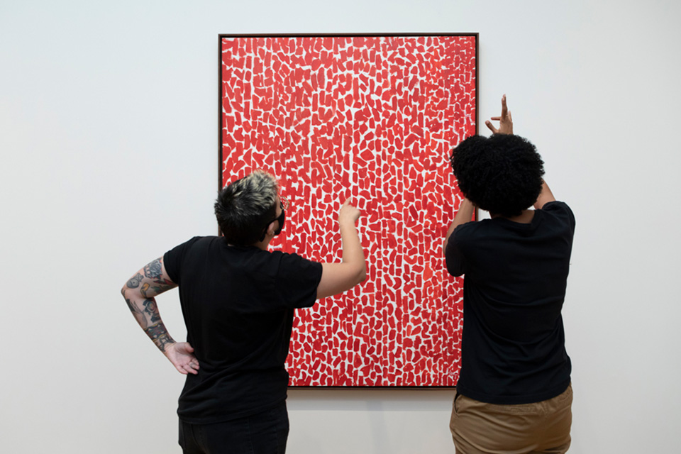 Visitors engage with Alma Thomas's Red Rose Cantata, 1973, acrylic on canvas, National Gallery of Art