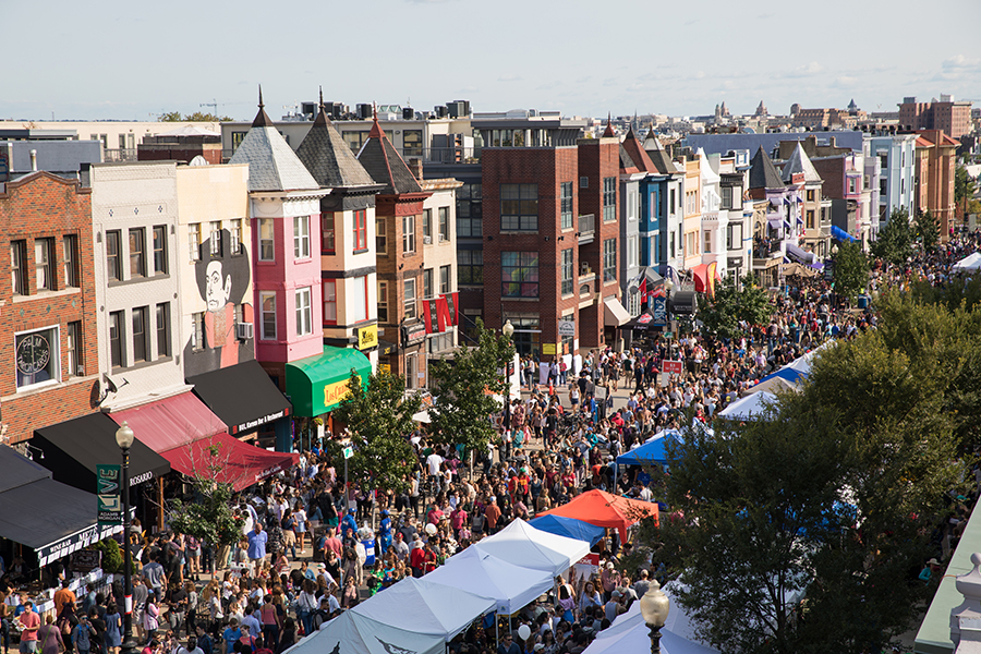 A large group of people on the street for the Adams Morgan Day festival 