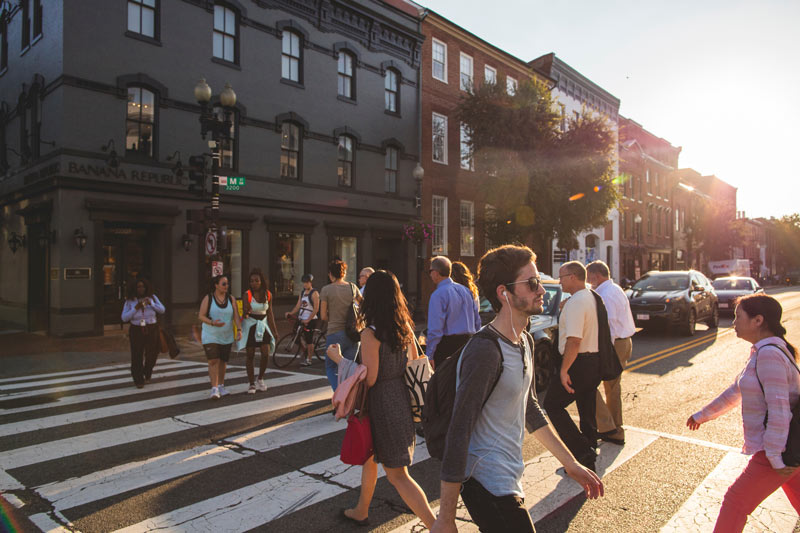 Walking across M Street NW in Georgetown - The best ways to get around Washington, DC