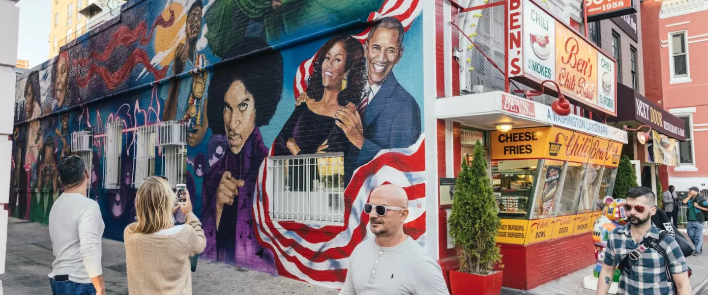 Guests Taking Photo of Ben's Chili Bowl Mural