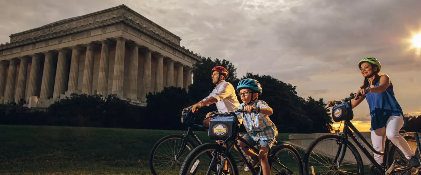 Family biking in front of Lincoln Memorial