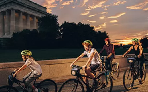 Family biking in front of Lincoln Memorial
