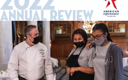 two students stand with a chef
