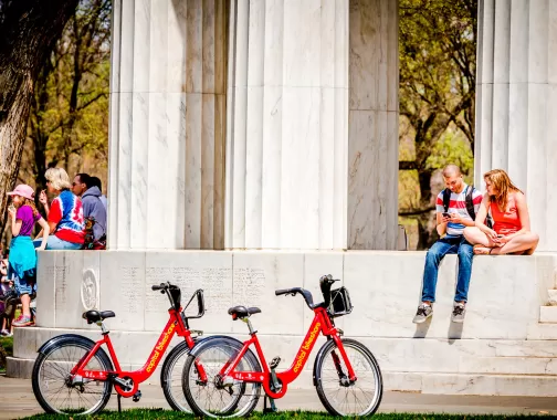 Couple with Capital Bikeshare Bikes at DC War Memorial - Washington, DC