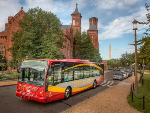 DC Circulator bus on the National Mall in front of the Smithsonian Castle - How to get around Washington, DC