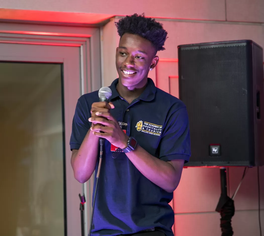 Jashawn Evans holding a microphone and speaking at the AEF July 4th Event