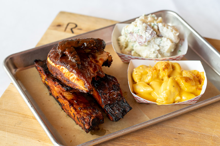 barbecue tray with sides of Mac and cheese and potato salad